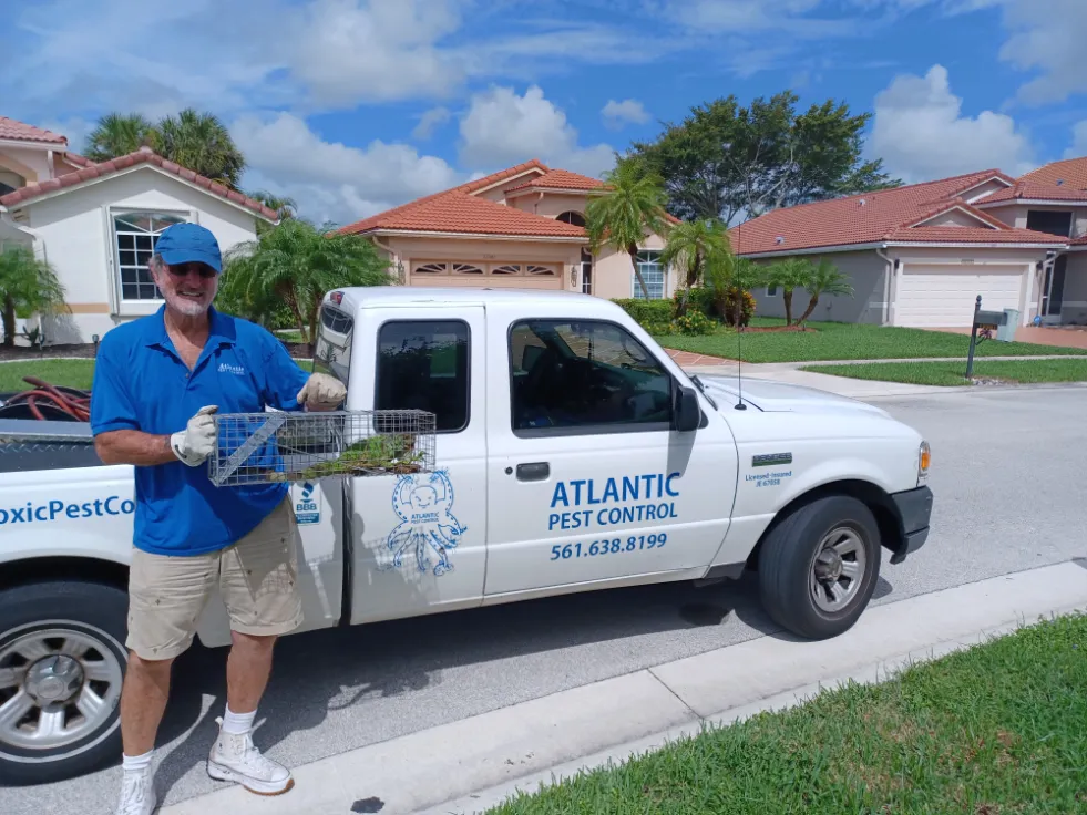 charlie of atlantic pest control cleaning out the gutters